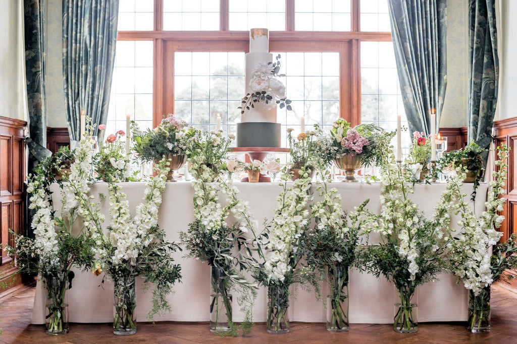Wedding cake table with large white floral display
