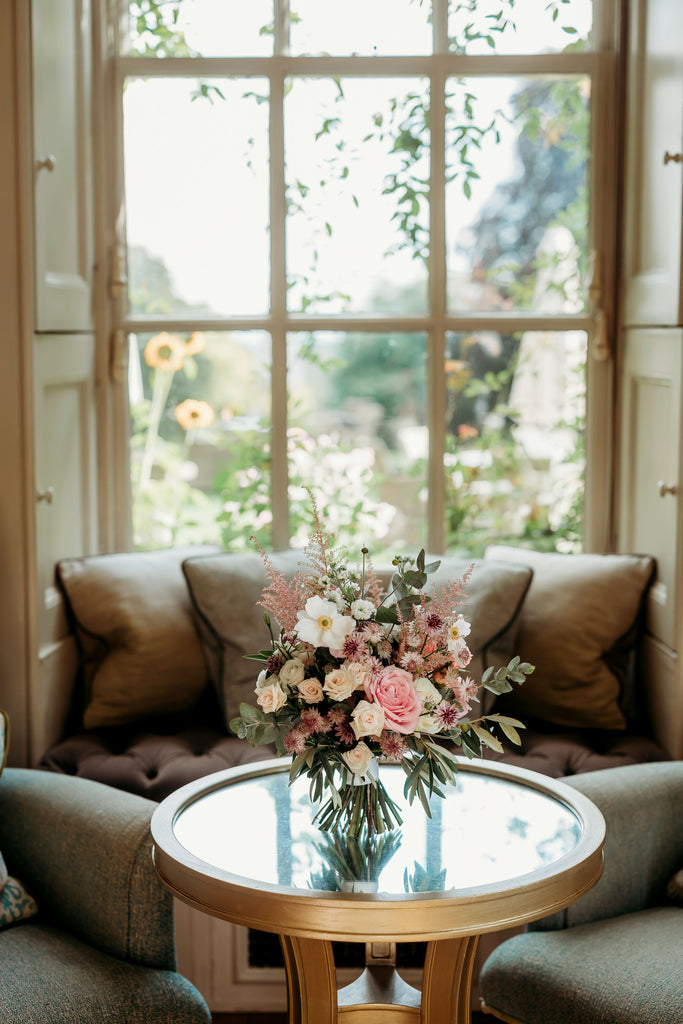 Bridal bouquet on a table in front of a window
